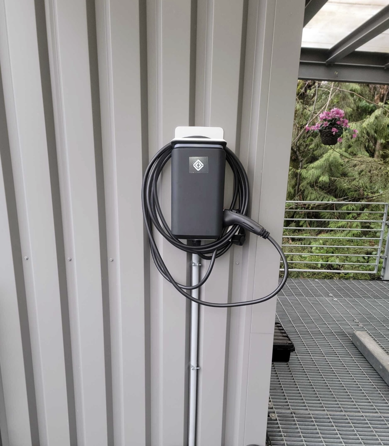 Wall-mounted Level 2 EV charger with tidy cable storage.