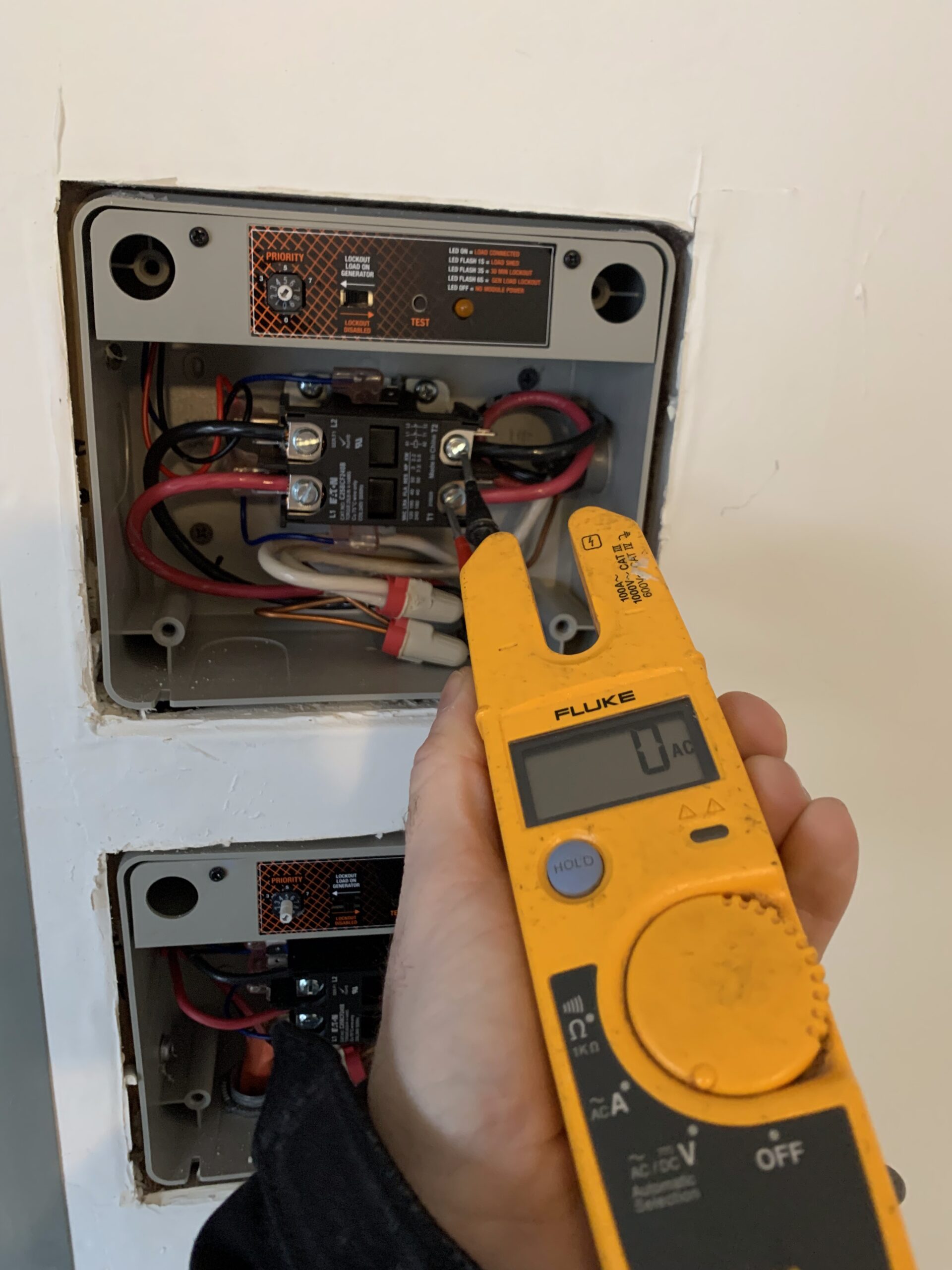 Electrician troubleshooting a residential electrical system