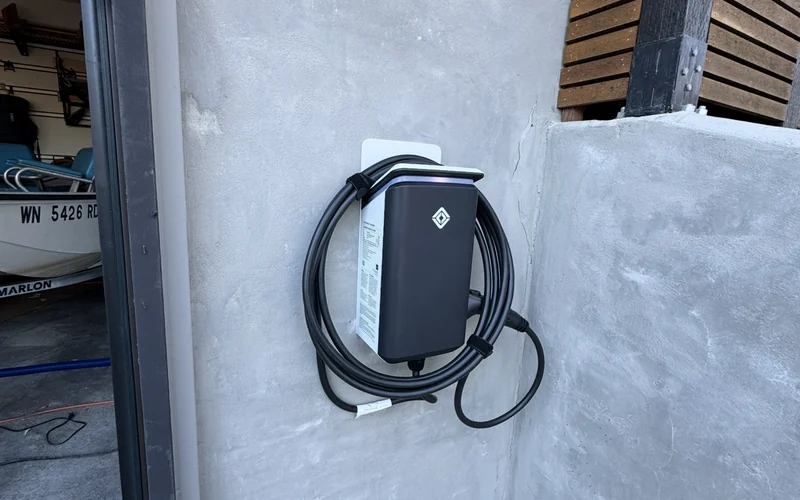Exterior wall-mounted electric vehicle charger and cable