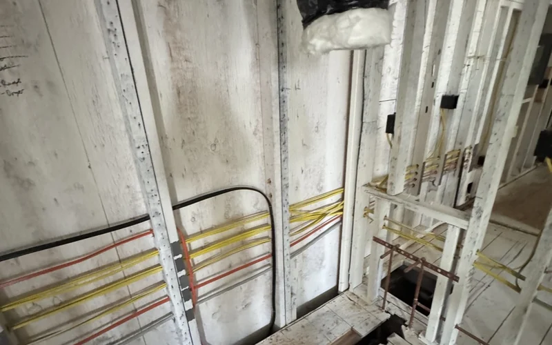 Branch-circuit wiring routed through exposed wall framing